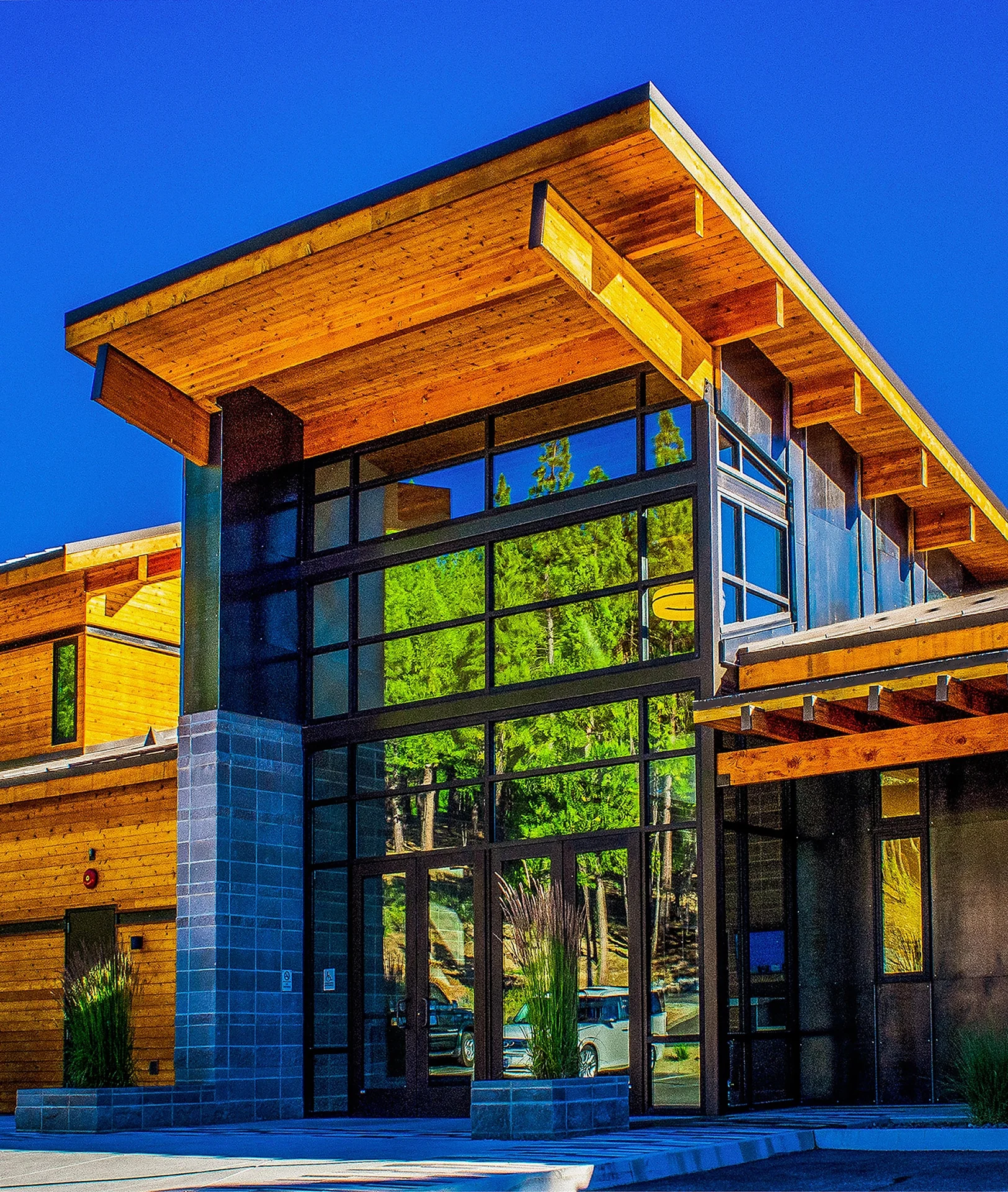 Tall glass prow under an upswept timber roof