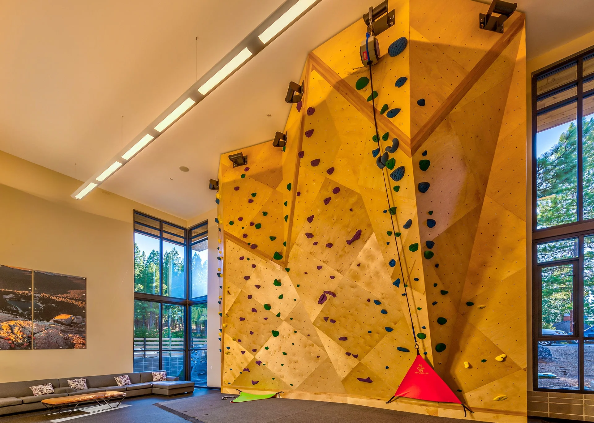 Climbing gym with a tall sculpted climbing wall and clerestory windows