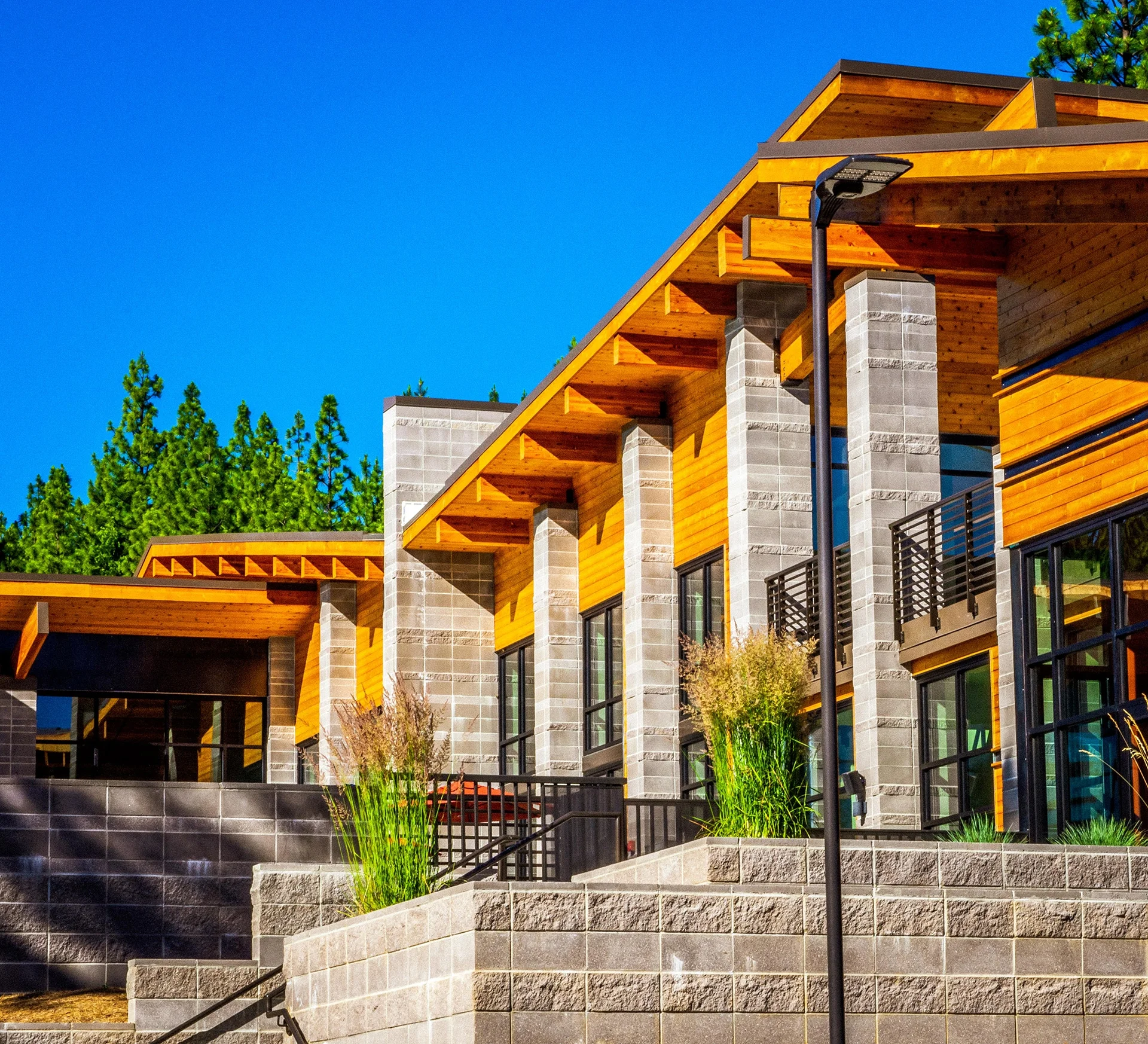 Stacked masonry piers and deep timber eaves along the building
