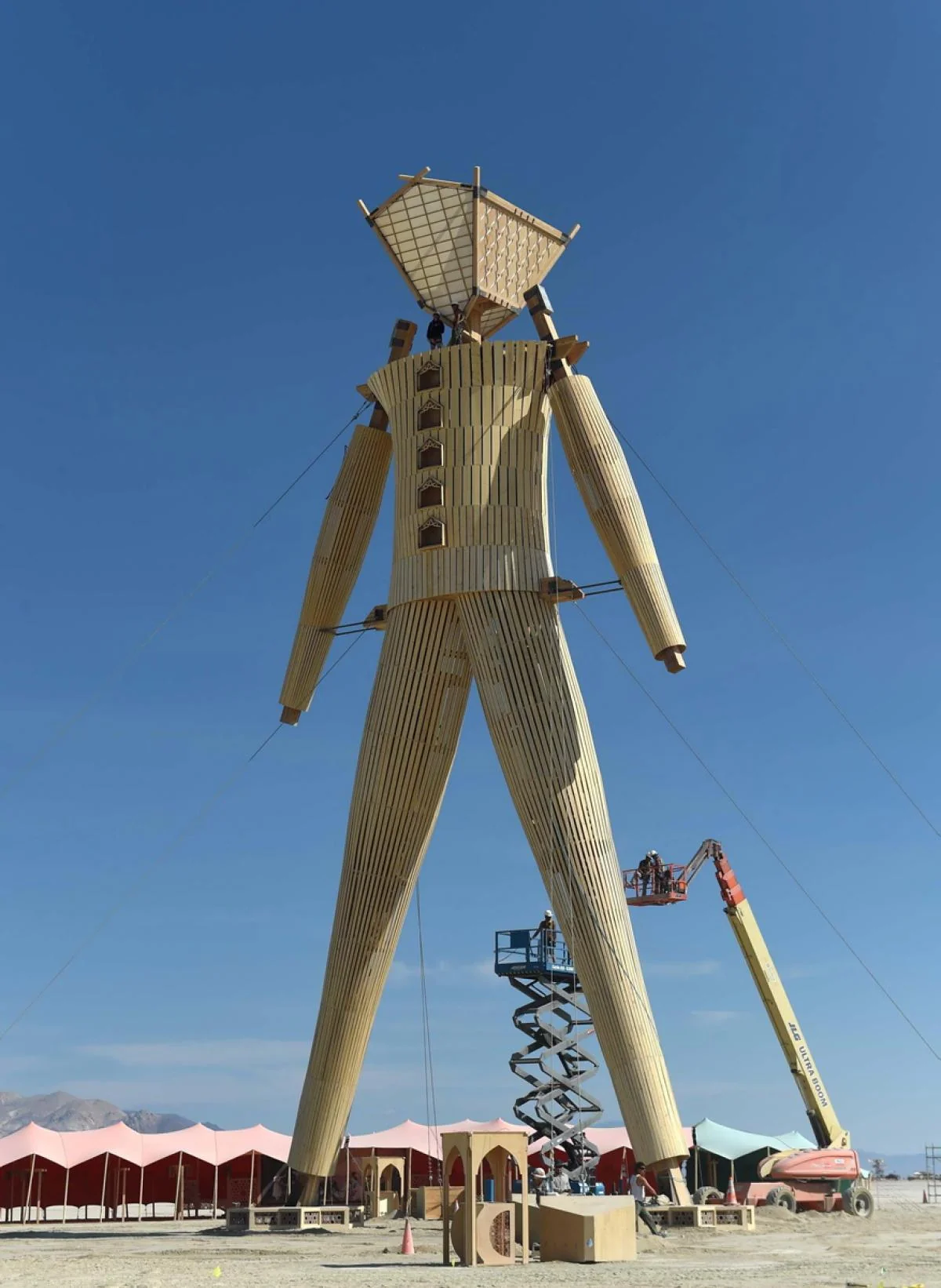 The Man under construction with lifts and scaffolding at its base