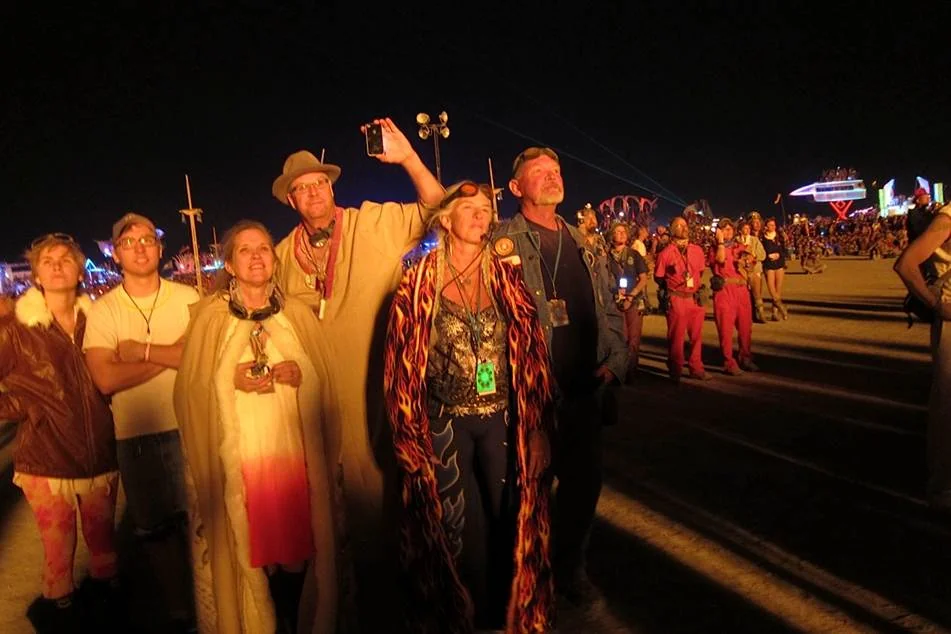 A group gathered on the playa at night