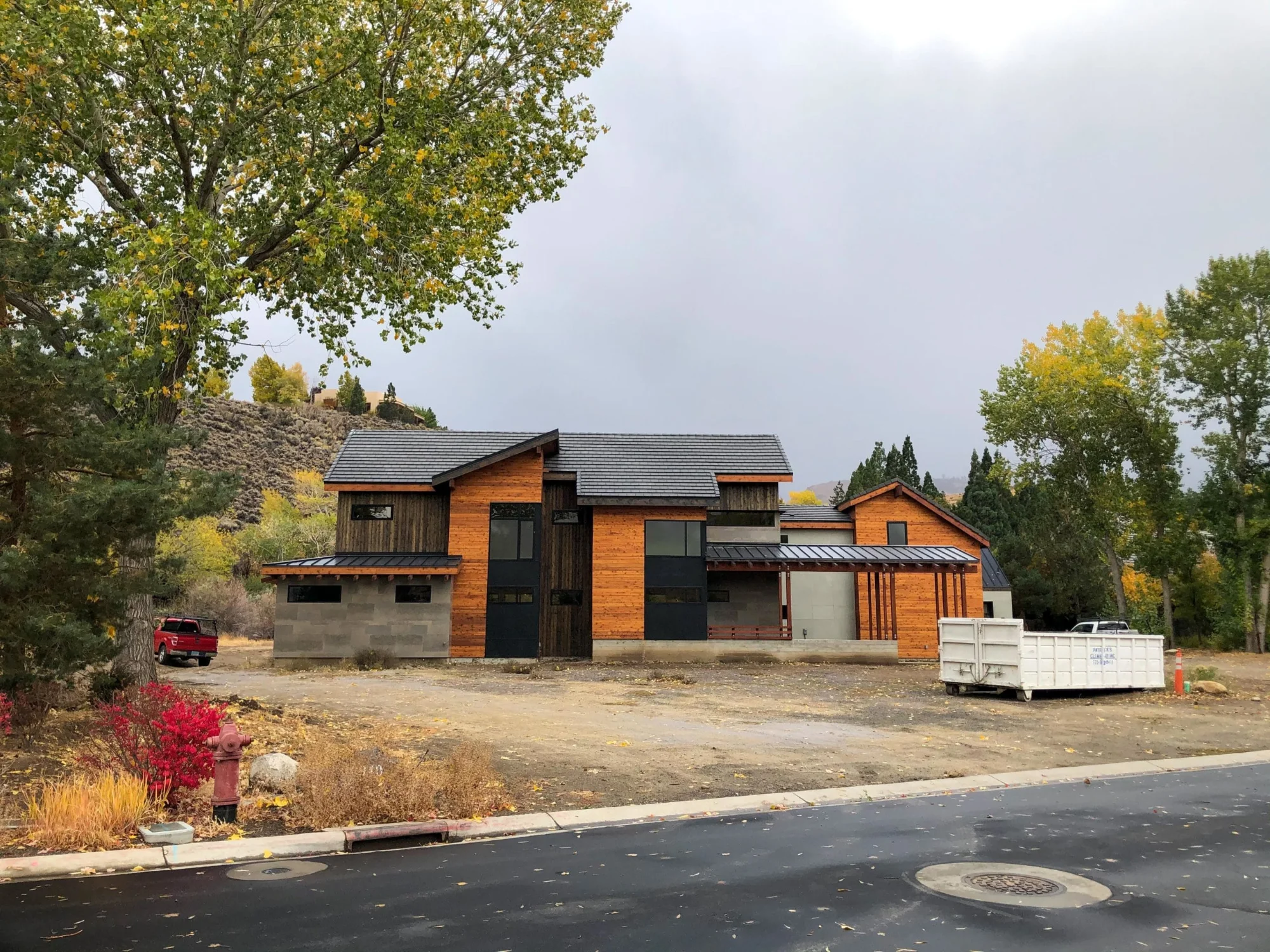 Street view of the Eagle Creek Residence with stone base and cedar gables