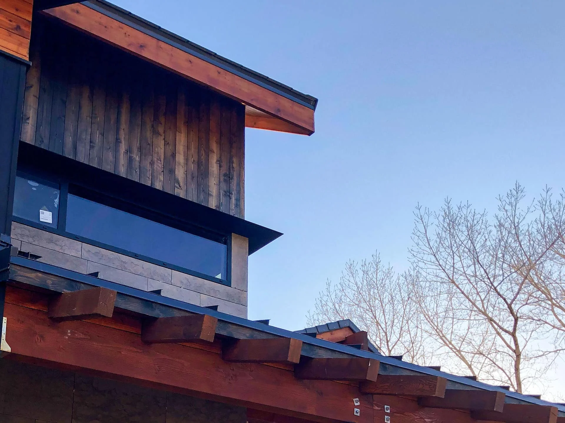 Deep roof eave shading a band of windows