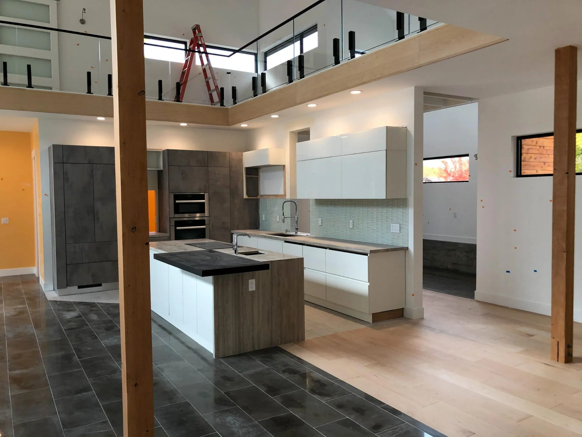 Kitchen with large windows looking out to the trees