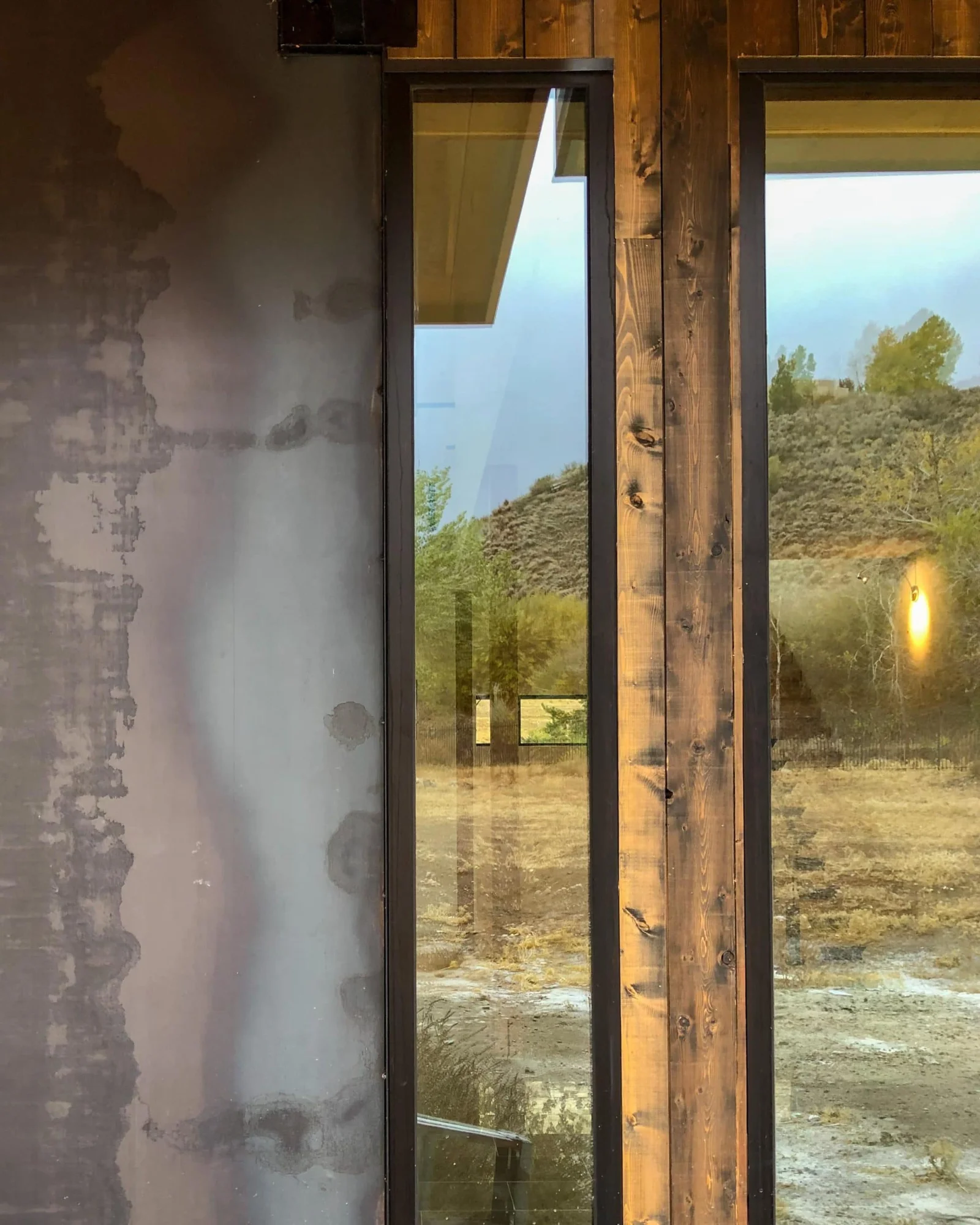Close view of a window set in cedar siding