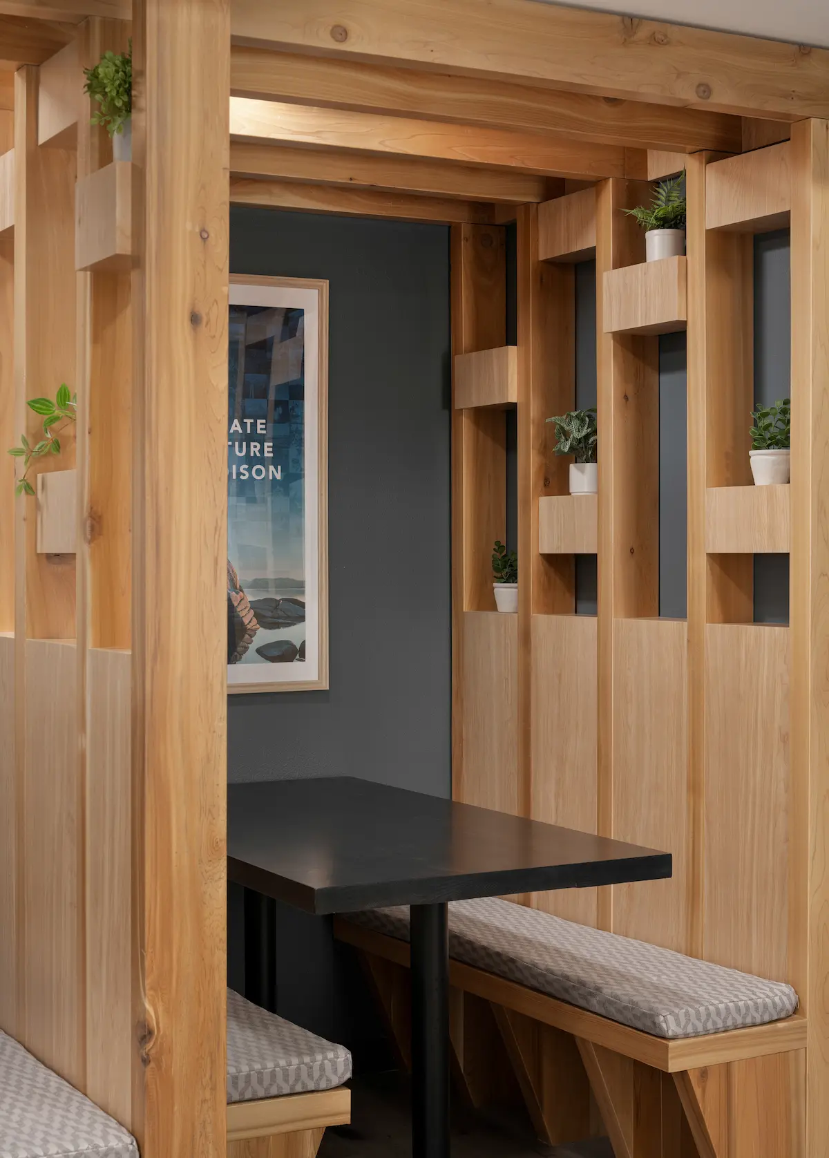 Wood-slat study booth with built-in bench and table