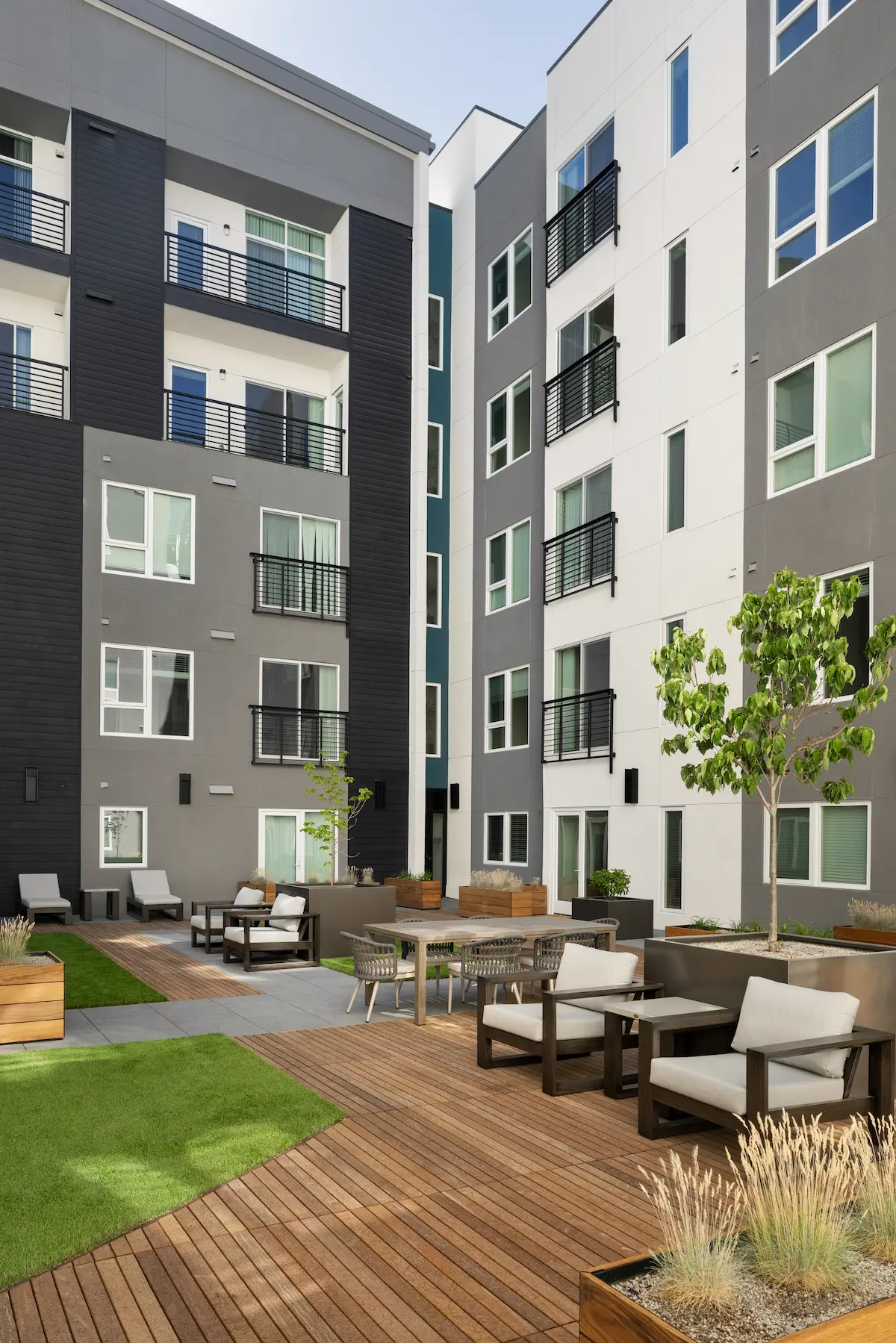 Rooftop garden courtyard with plantings, seating, and wood deck