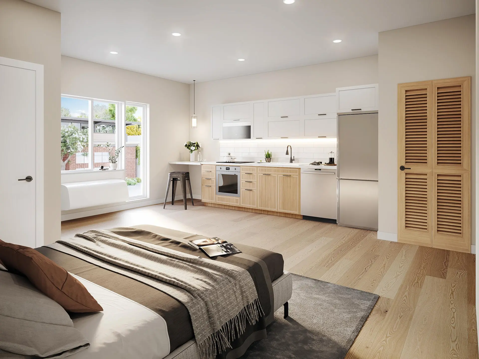 Bright studio unit with bed, kitchen, and wood-look flooring