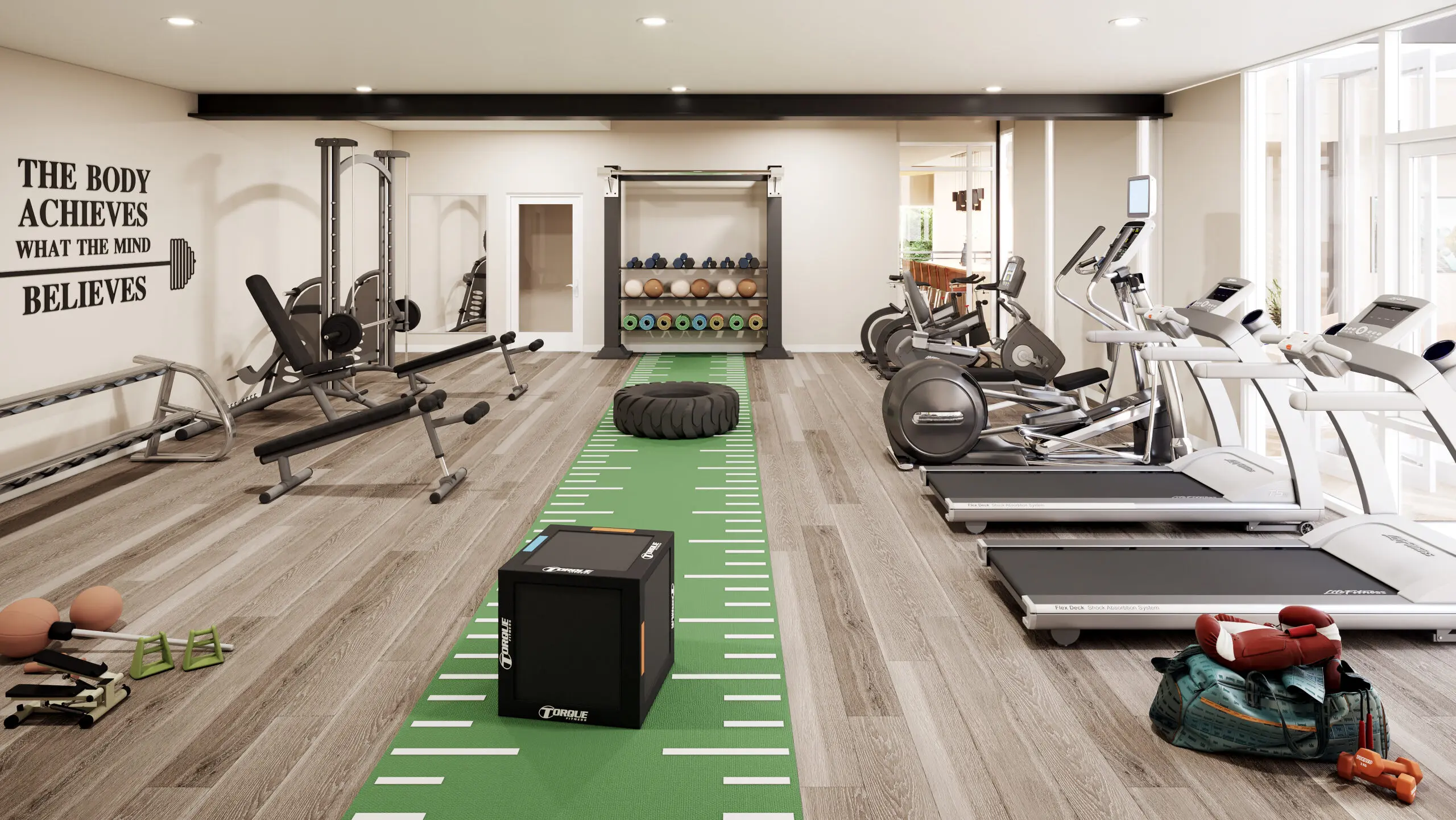 Fitness center with cardio machines and a turf training lane