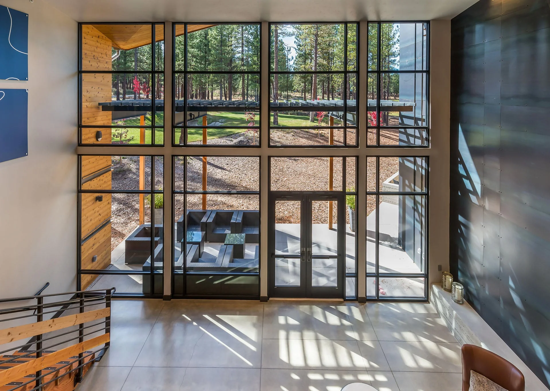 Glass entry vestibule seen from inside with a view to the terrace