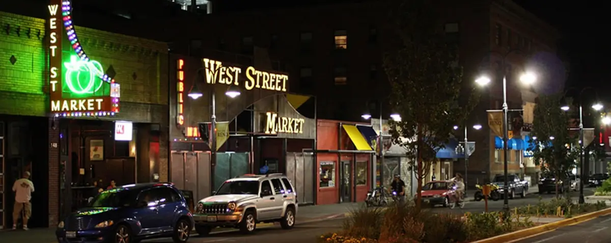 West Street Market at night with glowing neon market signage along the street